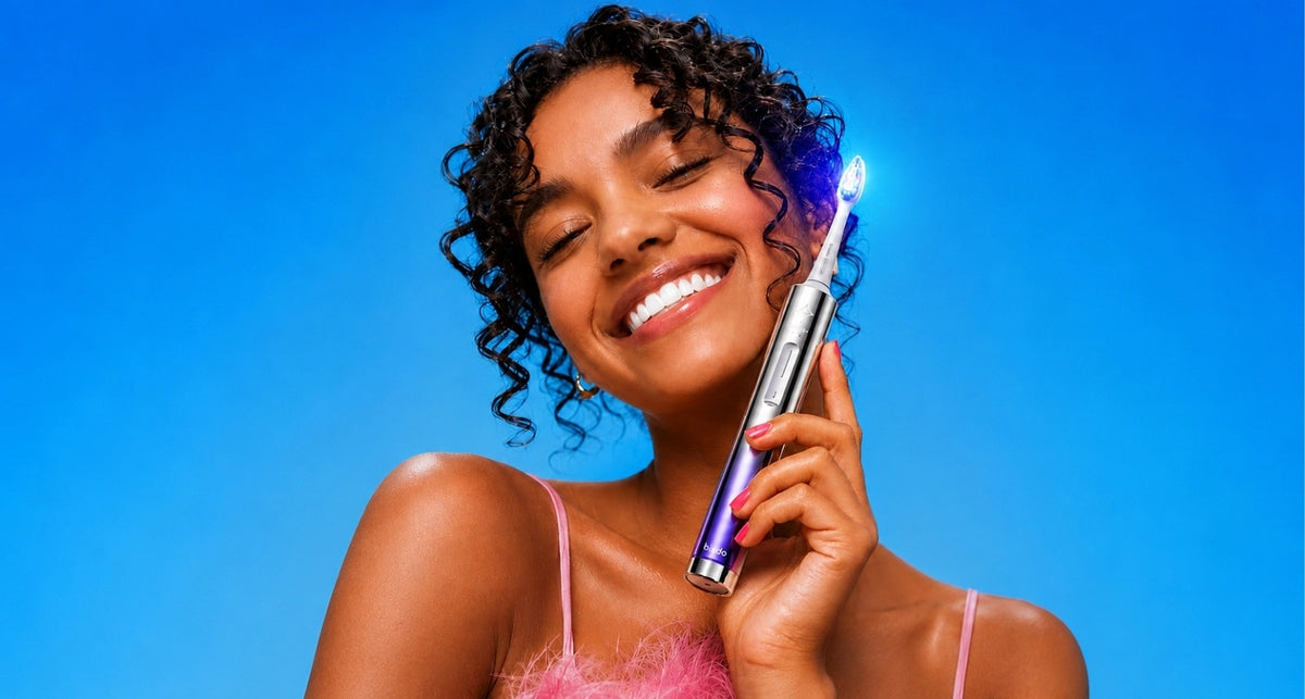 Conceptual Glossonic Brush PRO and whitening toothpaste in a silver studio composition